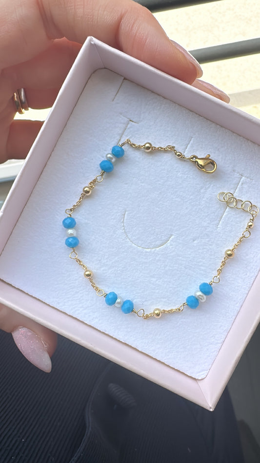 BRACCIALE CON TRIS PERLA CENTRALE E CRISTALLI LATERALI